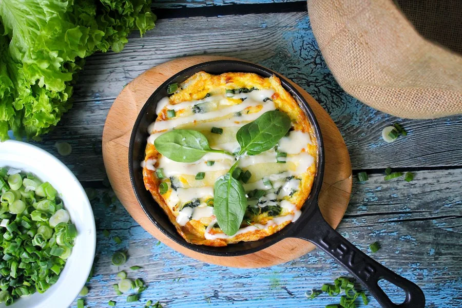 Omelete com espinafre e queijo na frigideira